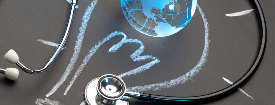 A stethoscope and a globe over a chalk illustration of a lightbulb