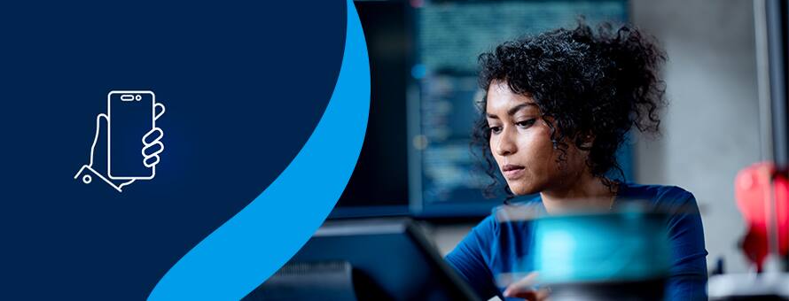 A woman working in information technology sitting at a desk with an outline of a hand holding a phone to the left on a blue background