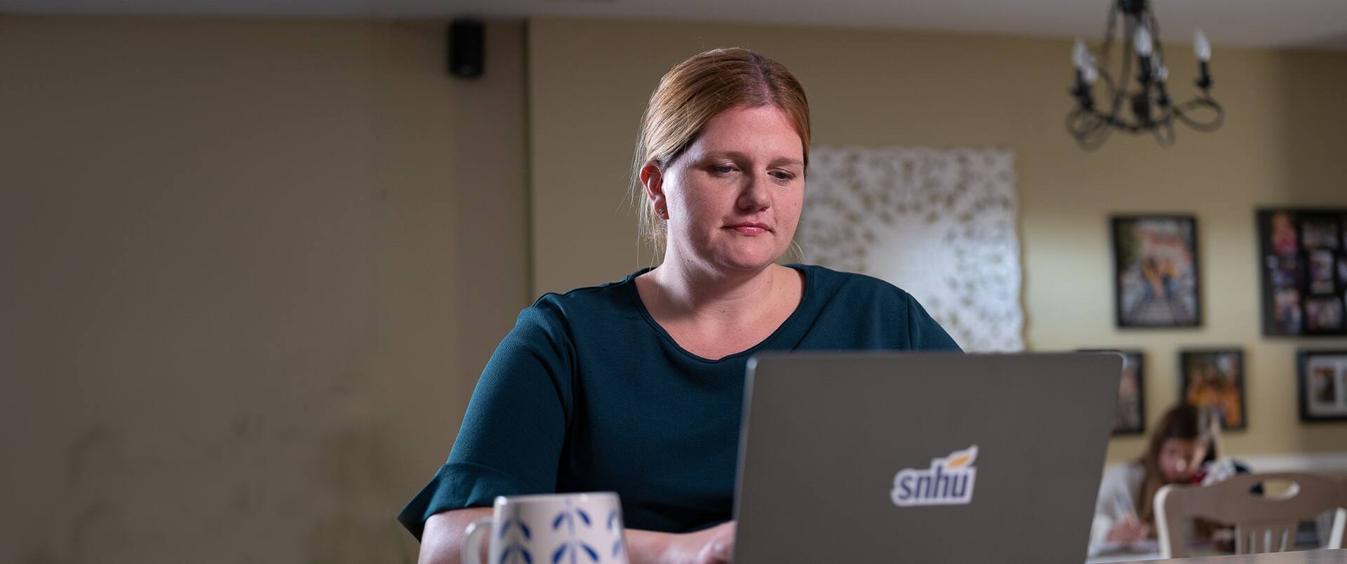 2019 online criminal justice degree graduate Shelly Villa, working from a laptop computer.
