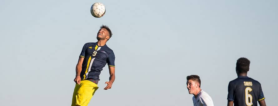 A student-athlete playing soccer