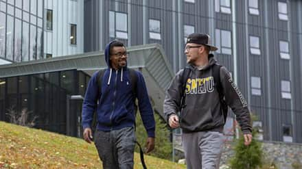 Two students walking in front of Monadnock Hall.