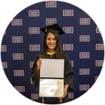 Diana Tafoya Sanchez, a Hawaii resident and SNHU graduate, wearing her cap and gown and holding her diploma.