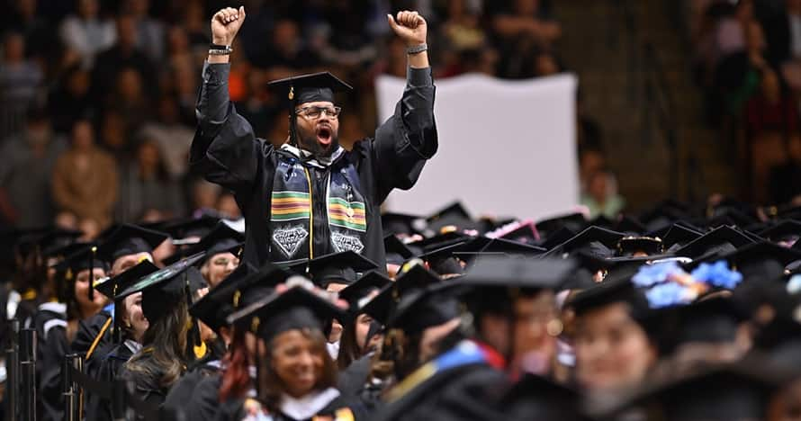 SNHU student celebrating at commencement ceremony. 